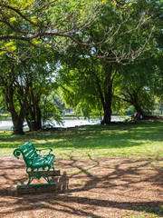 Empty wooden chair in public park