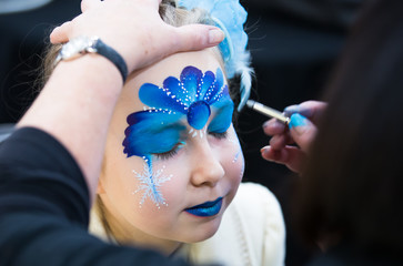 Christmas face painting, Portrait of little girl during the face painting session © IRStone