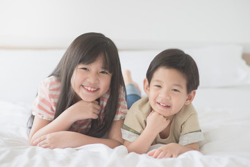 Cute asian children lying