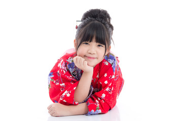 Beautiful Asian girl  in red kimono lying on white background isolated