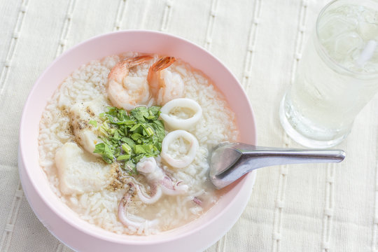 Boiled rice seafood with shrimp, squid, snapper or mush delicious breakfast Thai food.