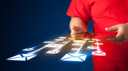 Hand holding tablet and sending email icons