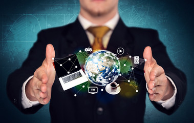 Business person holding laptop and globe