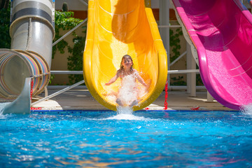 girl rolls down the water slides at the water park