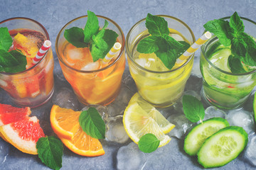 Refreshing summer drinks water with ice and lemon, orange, grape