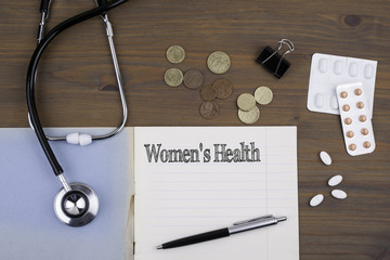 Doctor's desk with notebook and text - Women's Health
