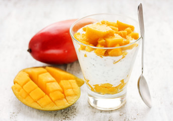 Diet breakfast concept - layered chia seed pudding with mango
