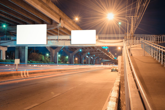 Night road long exposure with blank billboard