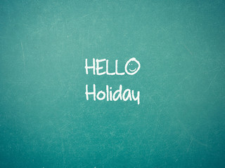 Fototapeta na wymiar Green blackboard wall texture with a word Hello Holiday