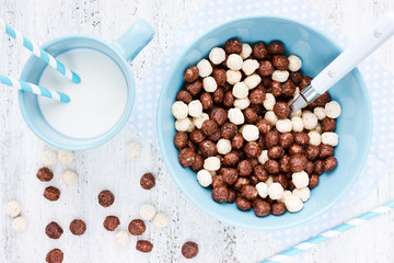 Cereal chocolate balls and cup of milk for breakfast