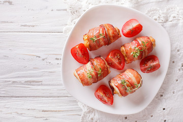 Stuffed chicken breast wrapped in bacon close-up. horizontal top view
