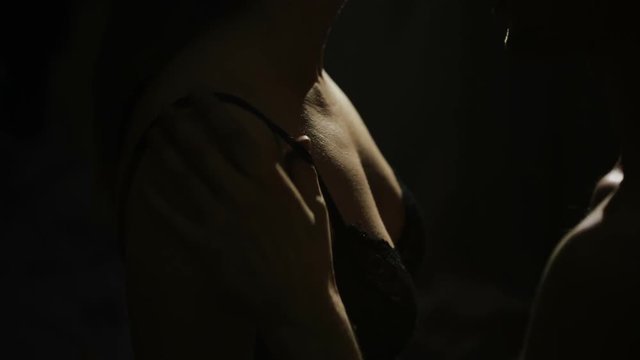 man undresses a woman. sexual games. Woman caressing