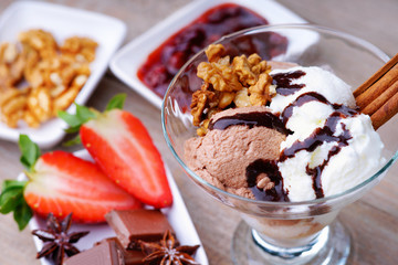 Ice cream sundae, chocolate, jam and sliced strawberry 