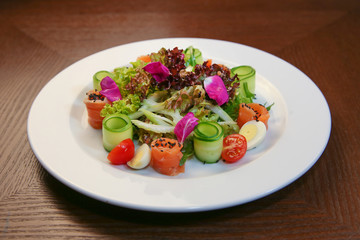 Fresh salad with chicken, tomatoes and mixed greens