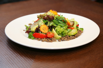 Fresh salad with chicken, tomatoes and mixed greens