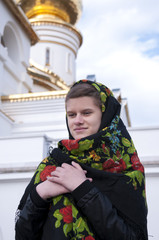 Russian girl in a headscarf near the temple