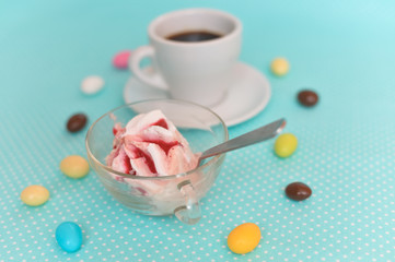 Fototapeta na wymiar Closeup on fruit icecream, coffee cup and candies. Composition light blue background