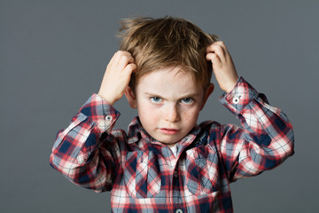 unhappy kid scratching his hair for head lice or allergies - 112444432