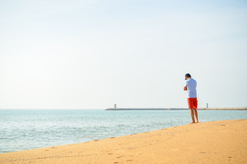 Man standing with the ocean in the background.