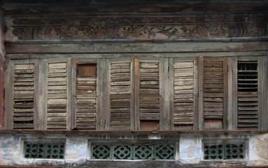 Fototapeta na wymiar Antique wooden windows on an old building. Architectural elements.