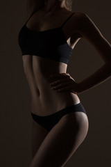 Naklejka premium silhouette of slim woman body in black low key
