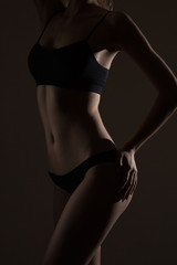 Naklejka premium silhouette of slim woman body in black low key