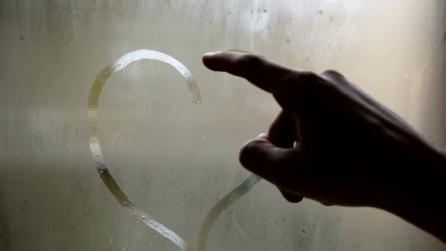 Heart symbol Drawing on the Misted Window