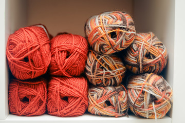 Colorful balls of wool piled up on shelf