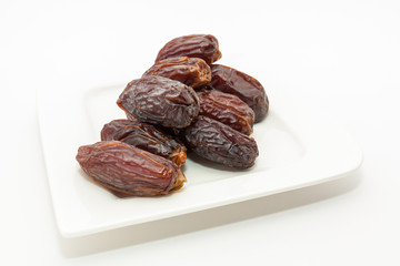 Date fruits in white plate - Ramadan, Eid background