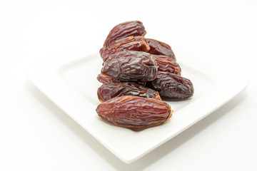 Date fruits in white plate - Ramadan, Eid background