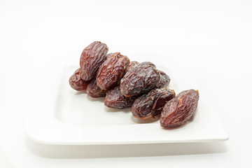 Date fruits in white plate - Ramadan, Eid background