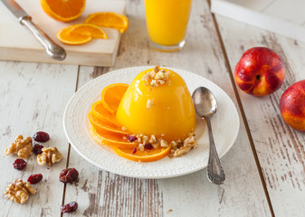 Orange jelly served on an old white painted table