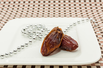 Date fruits in white plate - Ramadan, Eid background