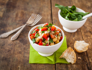 Chickpea salad on a worn out wooden table