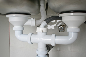 Drain pipes under a kitchen sink