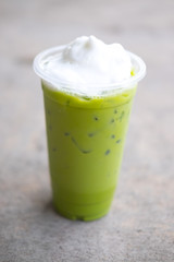 Cold Matcha green Tea fresh on glass whipping cream topping