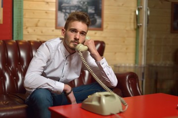young man with old phone vintage style