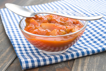 bowl of hot sauce on wood