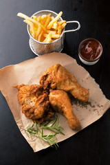 Fried chicken legs with fried potatoes