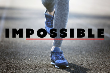 Changing the word impossible to possible on asphalt road with feet
