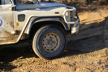Fototapeta na wymiar An SUV fighting for grip on a dirt track, 