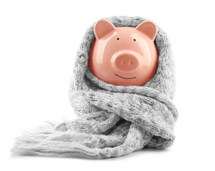Piggy bank wearing scarf, isolated on white. Saving heating concept