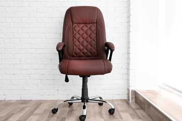 New office chair on the brick wall background
