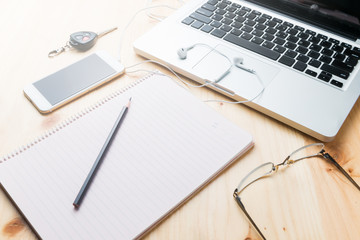 blank notebook with pencil and laptop