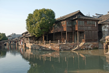Shanghai, Wuzhen historic scenic town typical old houses reflection in a canal.  