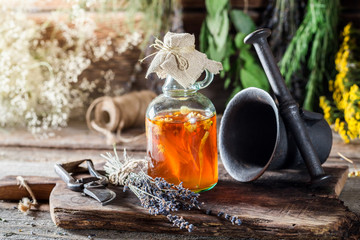 Medicine in bottles made of honey and fresh herbs