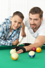  father and son playing billiards