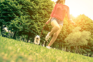 Young girl running with her dog