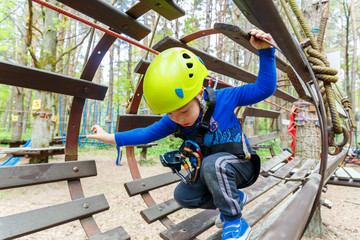 Portrait of 3 years old boy wearing helmet and climbing