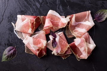 Curled Slices of Delicious Prosciutto with spice  Italian cuisine